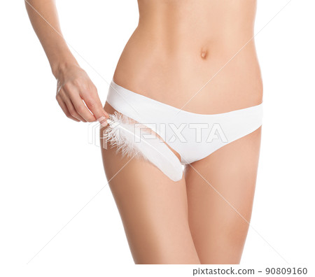 Woman with flower showing smooth skin after bikini epilation on beige background, closeup 90809160