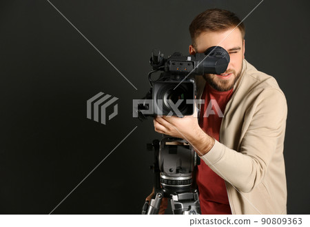 Operator with professional video camera on black background, space for text Operator with professional video camera on black background, space for text 90809363
