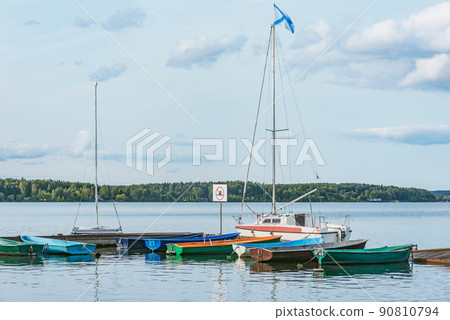 Boats by the pier. 90810794