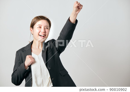 A young woman in a jacket doing a guts pose 90810902