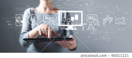 Stock trading theme with woman using a tablet Stock trading theme with woman using a tablet 90811221