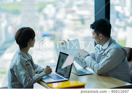 A major developer in a uniform having a meeting in a skyscraper 90811697