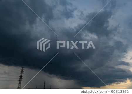Summer sky where the weather suddenly changes and dark clouds begin to cover Power transmission towers and rain columns Summer sky where the weather suddenly changes and dark clouds begin to cover Power transmission towers and rain columns 90813551