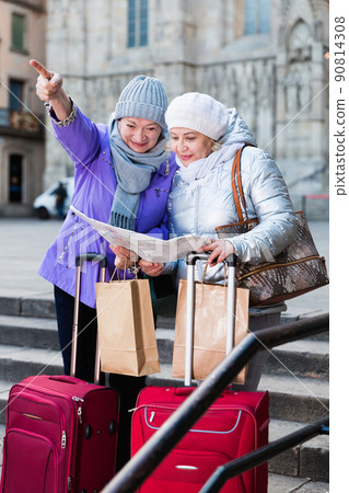 Senior females traveling with city map 90814308