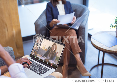 African american businessman during online meeting with multiracial colleagues in office African american businessman during online meeting with multiracial colleagues in office 90814383