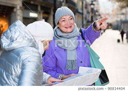 Senior females traveling with city map 90814404