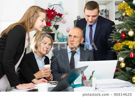 Group of successful managers sums up their work for the year in the office Group of successful managers sums up their work for the year in the office 90814620