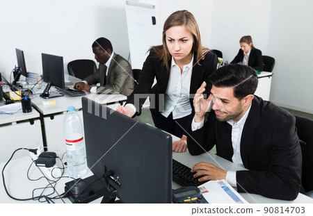 Unhappy manager working at laptop Unhappy manager working at laptop 90814703