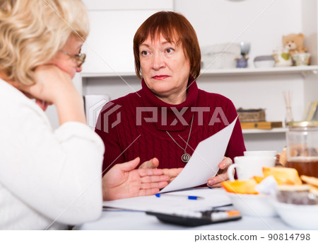 females at the table with utilities bills females at the table with utilities bills 90814798
