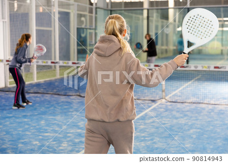 Padel players, woman playing match on court at fitness center 90814943