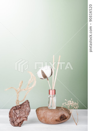 hygge and aromatherapy concept. aroma reed diffuser, cotton bud on white table at home. minimal style composition. winter and autumn mood. hygge and aromatherapy concept. aroma reed diffuser, cotton bud on white table at home. minimal style composition. winter and autumn mood. 90816520