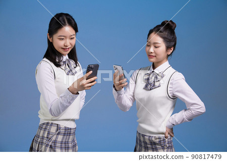mz generation, asian girl students looking at smartphones photo images 90817479
