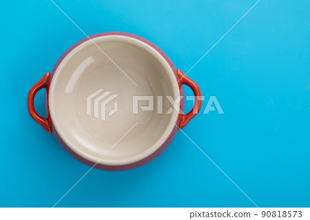 Cocotte Tableware that shines on a blue background 90818573