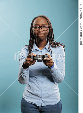 Portrait of young adult person enjoying leisure time by playing videogames on console device with modern gaming controller. Unpleased woman dissapointed because of lost game match. Portrait of young adult person enjoying leisure time by playing videogames on console device with modern gaming controller. Unpleased woman dissapointed because of lost game match. 90823106