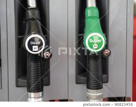 Rome, Italy - May 31, 2022: Fuel pump nozzles for different kinds Diesel B7 and Super E5 in a filling station 90823458