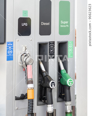 Rome, Italy - May 31, 2022: Fuel pump nozzles for LPG, Diesel B7 and Super E5 in a filling station 90823623