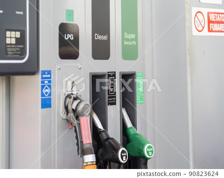 Rome, Italy - May 31, 2022: Fuel pump nozzles for LPG, Diesel B7 and Super E5 in a filling station 90823624