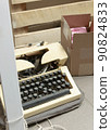an old typewriter, a fragment of blinds, a cardboard box on the background of wooden boards 90824833