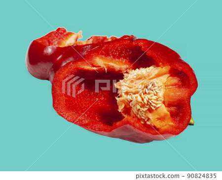 gutted red pepper with seeds on a colored turquoise background. macro 90824835