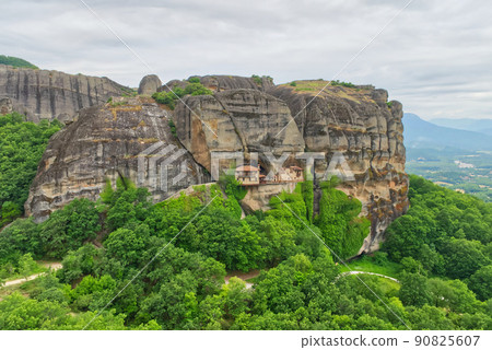 Stone monastery in the mountains. Kalabaka, Greece summer cloudy day in Meteora mountain valley. Stone monastery in the mountains. Kalabaka, Greece summer cloudy day in Meteora mountain valley. 90825607