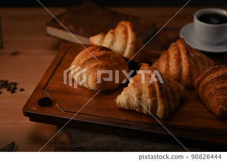 Tasty croissants on wooden cutting board ready to serve for breakfast. Breakfast, bread bakery products cafe concept 90826444