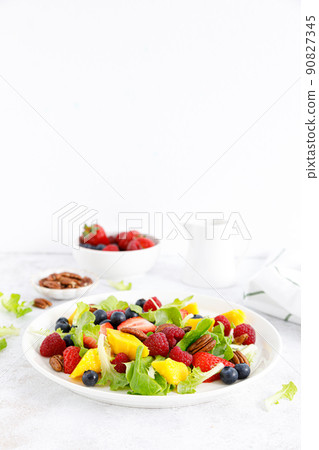 Fruit and berry salad with strawberry, blueberry, raspberry, mango and pecan nuts. Healthy food, diet Fruit and berry salad with strawberry, blueberry, raspberry, mango and pecan nuts. Healthy food, diet 90827345