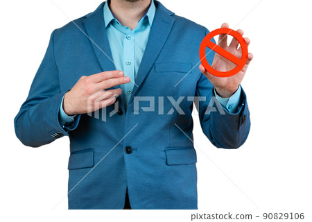 Businessman holds a red NO prohibition symbol Businessman holds a red NO prohibition symbol 90829106