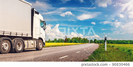 Truck moving on the asphalt country highway in sunny day in spring 90830466