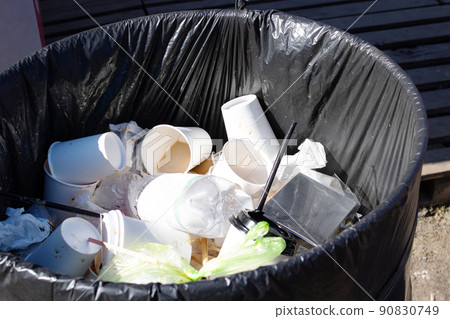 Plastic cups in a street trash can 90830749