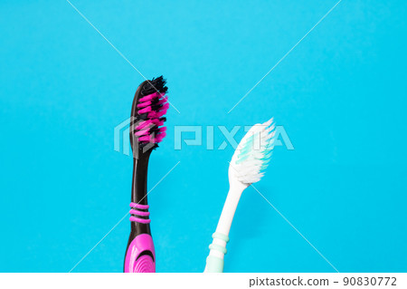 Two toothbrushes on a blue background closeup 90830772