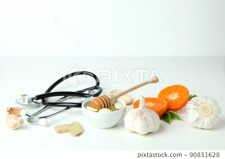 Concept of treatment colds with honey and garlic on white background 90831628