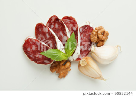 Concept of tasty food with salami sausage on white background Concept of tasty food with salami sausage on white background 90832144