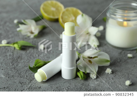 Concept of cosmetic with eco hygienic lipstick on gray textured background Concept of cosmetic with eco hygienic lipstick on gray textured background 90832345