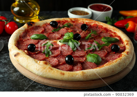 Concept of tasty food with Salami pizza on dark background 90832369