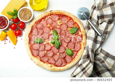 Concept of tasty food with Salami pizza on white wooden background 90832405
