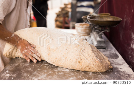 male hands knead yeast dough for baking bread 90833510
