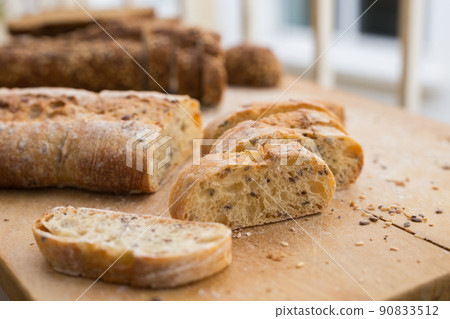 fresh loaf of bread on wooden board 90833512