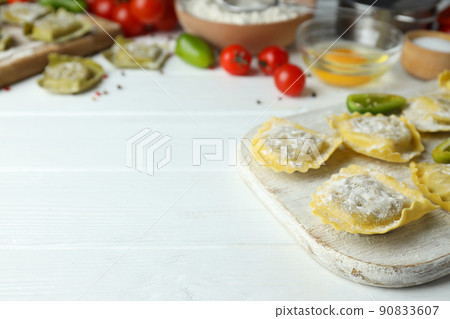 Concept of cooking ravioli on white wooden background Concept of cooking ravioli on white wooden background 90833607