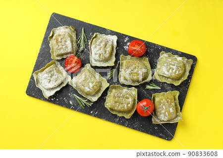 Concept of cooking ravioli on yellow background Concept of cooking ravioli on yellow background 90833608