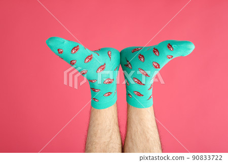 Male legs in socks with meat slices on pink background 90833722