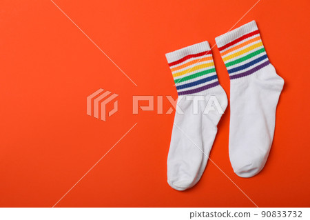Pair of LGBT socks on orange background Pair of LGBT socks on orange background 90833732