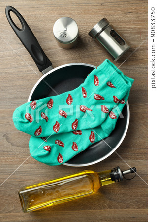 Cooking concept with socks with meat slices on wooden background 90833750
