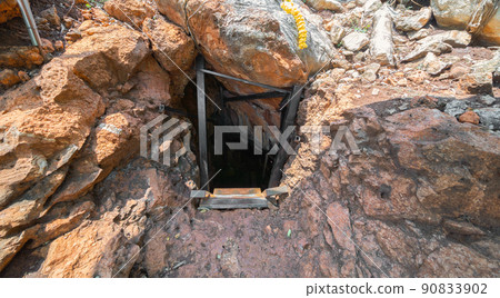 Natural stalactite and stalagmite rock stone cliff hang from cave ceiling in cave. Environmental explore. Landscape background. Erosion 90833902
