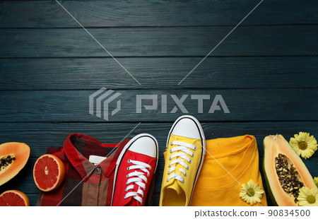 Summer clothes concept with sneakers on wooden background Summer clothes concept with sneakers on wooden background 90834500