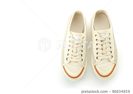 Pair of beige sneakers isolated on white background Pair of beige sneakers isolated on white background 90834859