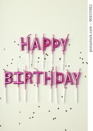 Happy birthday candles and glitter on white background Happy birthday candles and glitter on white background 90835062