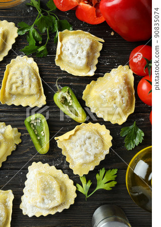 Concept of cooking ravioli on wooden background Concept of cooking ravioli on wooden background 90835074