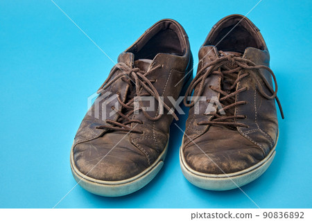 Beautifully aged vintage brown leather boots isolated on blue background 90836892
