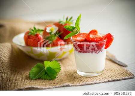 sweet homemade yogurt with strawberry jam and fresh strawberries in a glass cup sweet homemade yogurt with strawberry jam and fresh strawberries in a glass cup 90838185