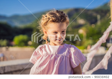 Emotional little girl in a pink dress Emotional little girl in a pink dress 90838402